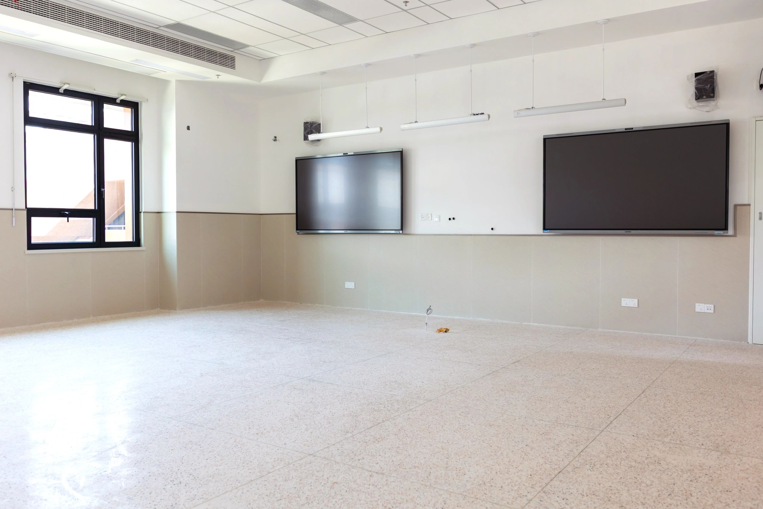 Wall-mounted display installation in a commercial room